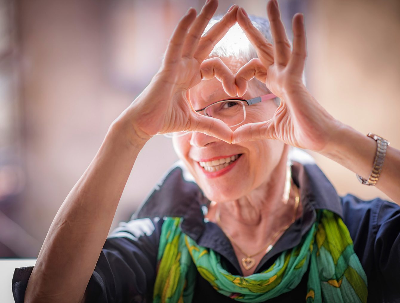 Woman making heart shape with hands
